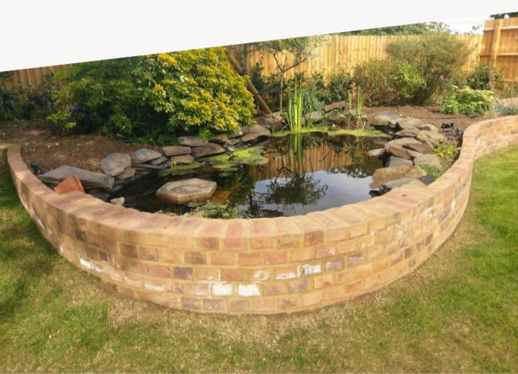 Newly installed modern sandstone paving and seating area in a Northampton garden by N&P Landscaping